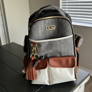 Itzy Ritzy Boss diaper bag with bow charm, pacifier holder, and black wallet